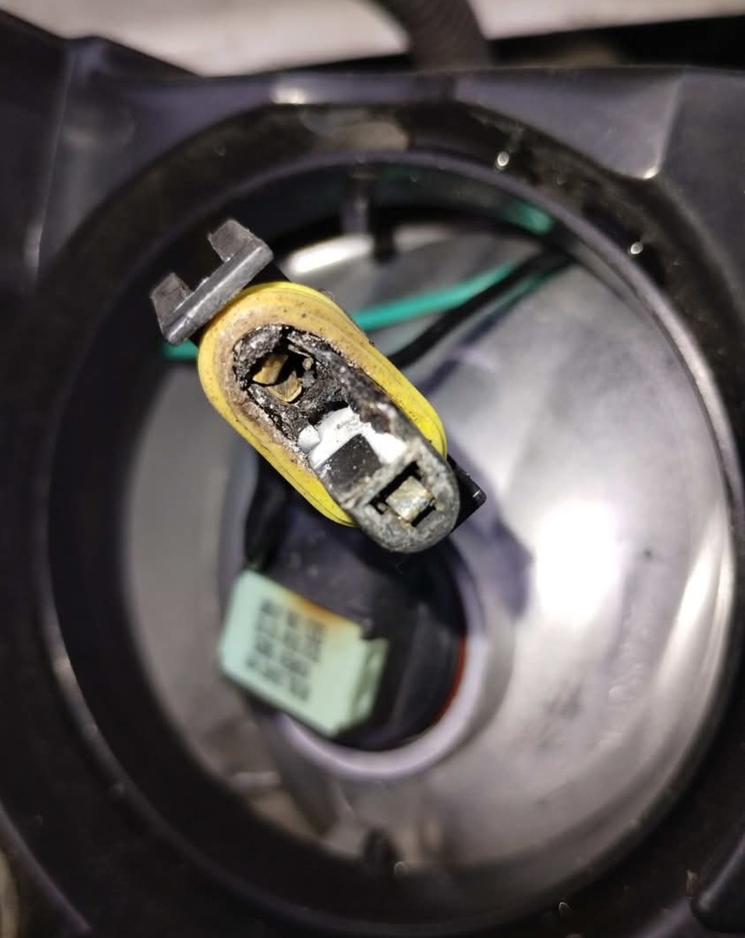 Burnt headlight connector pulled out for repair