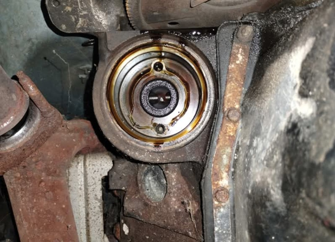 Engine seal and housing seen from underneath a car